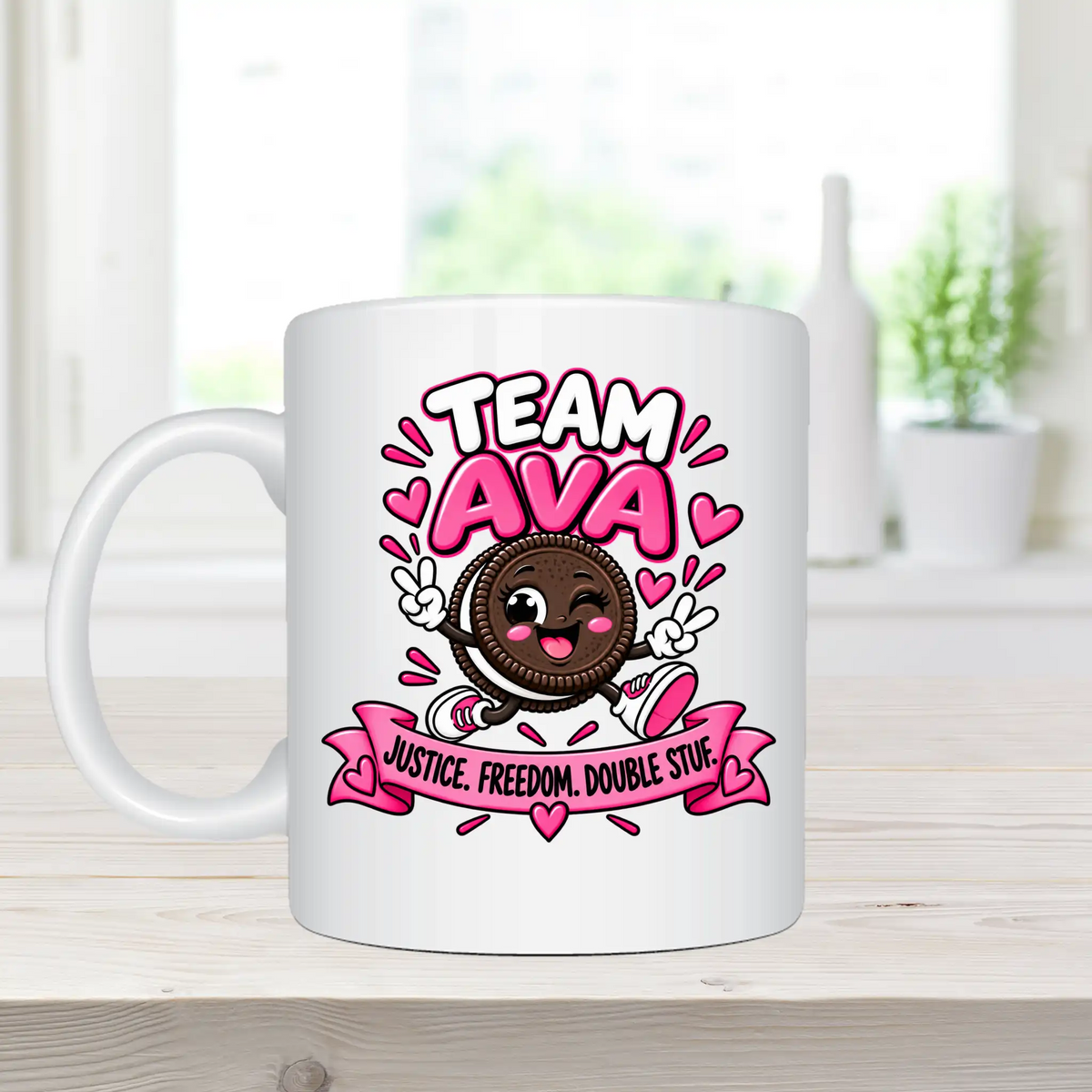 A white ceramic mug with a colorful cartoon graphic of an Oreo cookie and the text 'TEAM AVA' and 'JUSTICE. FREEDOM.